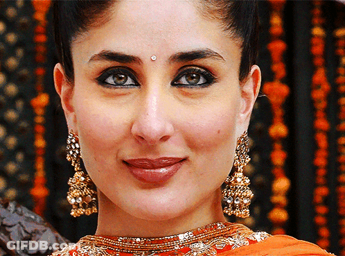 A Close Up Of A Woman Wearing Gold Earrings GIF