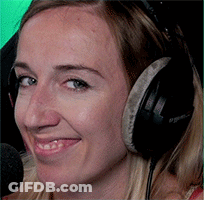 A Close Up Of A Woman Wearing Headphones And A Microphone GIF