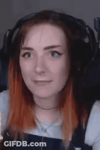 A Close Up Of A Woman Wearing Headphones And Making A Face . GIF