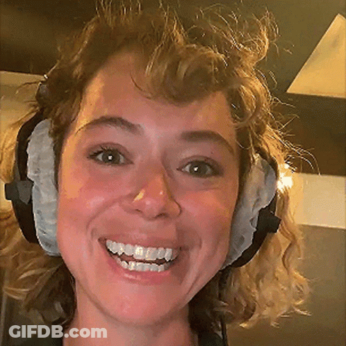 A Close Up Of A Woman Wearing Headphones Smiling GIF
