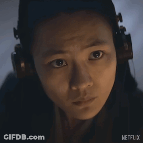 A Close Up Of A Woman Wearing Headphones With A Netflix Logo In The Corner . GIF