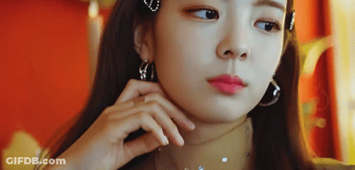A Close Up Of A Woman Wearing Hoop Earrings And A Choker GIF