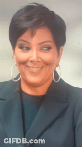 A Close Up Of A Woman Wearing Hoop Earrings GIF