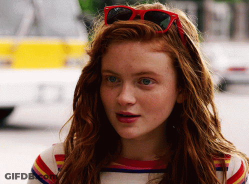 A Close Up Of A Woman Wearing Red Sunglasses GIF