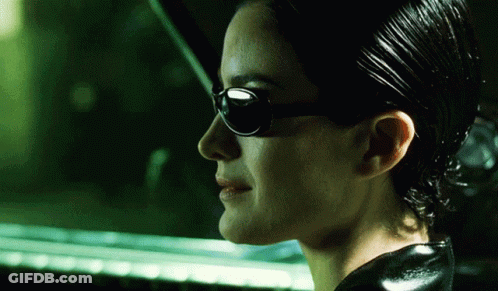 A Close Up Of A Woman Wearing Sunglasses And A Black Jacket GIF