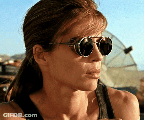A Close Up Of A Woman Wearing Sunglasses And A Black Tank Top GIF