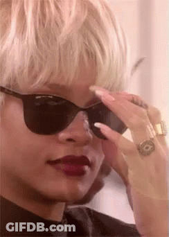 A Close Up Of A Woman Wearing Sunglasses And A Ring GIF