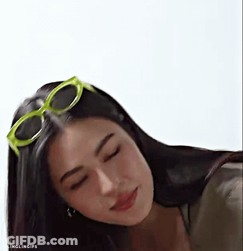 A Close Up Of A Woman Wearing Sunglasses And Looking Down . GIF