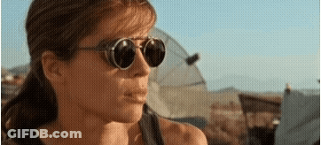A Close Up Of A Woman Wearing Sunglasses In A Desert . GIF