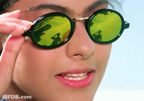 A Close Up Of A Woman Wearing Sunglasses With A Reflection Of A Person GIF