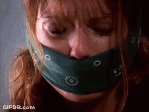A Close Up Of A Woman With A Bandana Around Her Mouth . GIF
