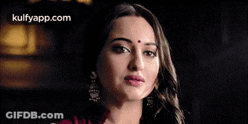A Close Up Of A Woman With A Bindi On Her Forehead . GIF