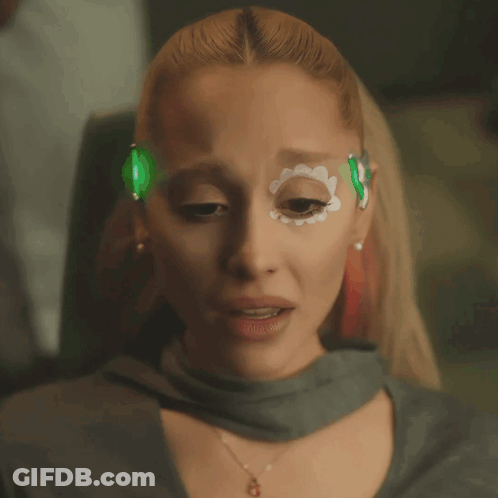A Close Up Of A Woman With A Flower Painted On Her Face GIF