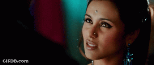 A Close Up Of A Woman With A Nose Ring And Earrings GIF