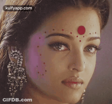 A Close Up Of A Woman With A Red Dot On Her Forehead GIF
