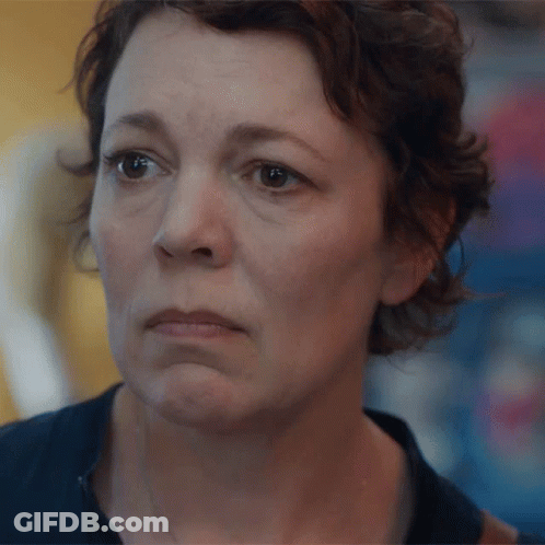 A Close Up Of A Woman With A Sad Look On Her Face GIF