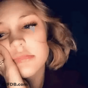 A Close Up Of A Woman With A Tear Coming Out Of Her Eye . GIF
