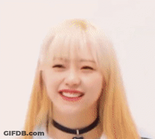 A Close Up Of A Woman With Blonde Hair And A Choker Smiling . GIF