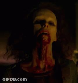 A Close Up Of A Woman With Blood On Her Face And Mouth . GIF