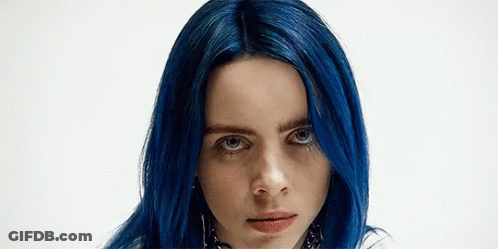 A Close Up Of A Woman With Blue Hair And Blue Eyes . GIF