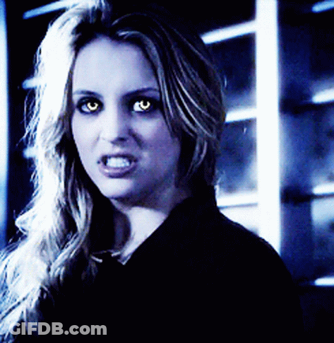 A Close Up Of A Woman With Glowing Eyes GIF