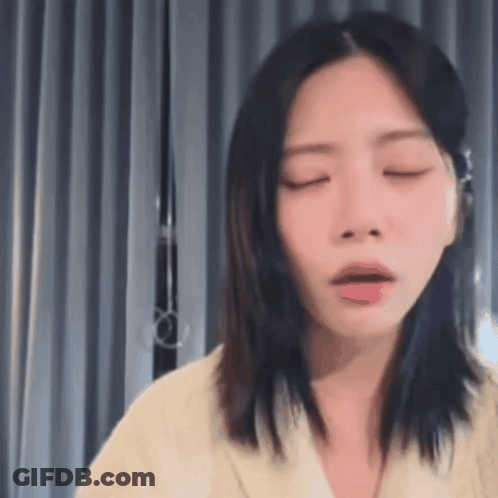 A Close Up Of A Woman With Her Eyes Closed . GIF