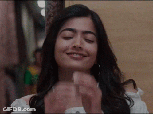 A Close Up Of A Woman With Her Eyes Closed And Her Hands Folded . GIF