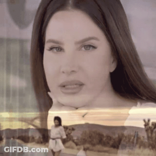 A Close Up Of A Woman With Her Hand On Her Chin GIF