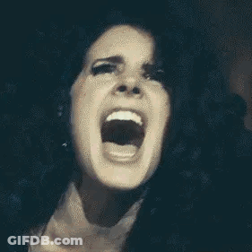 A Close Up Of A Woman With Her Mouth Open . GIF