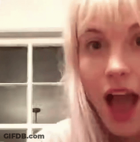 A Close Up Of A Woman With Her Mouth Open . GIF
