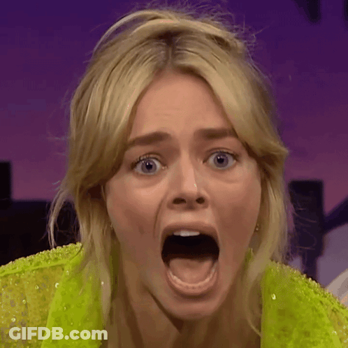 A Close Up Of A Woman With Her Mouth Wide Open GIF