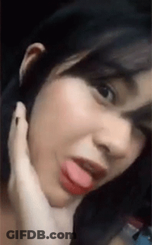 A Close Up Of A Woman With Her Tongue Out . GIF
