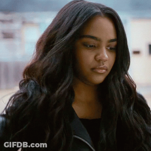 A Close Up Of A Woman With Long Black Hair Wearing A Black Jacket . GIF