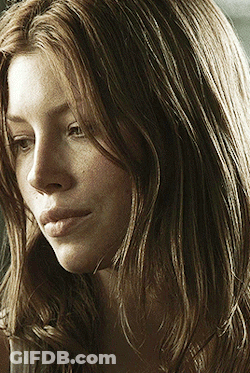 A Close Up Of A Woman With Long Brown Hair GIF
