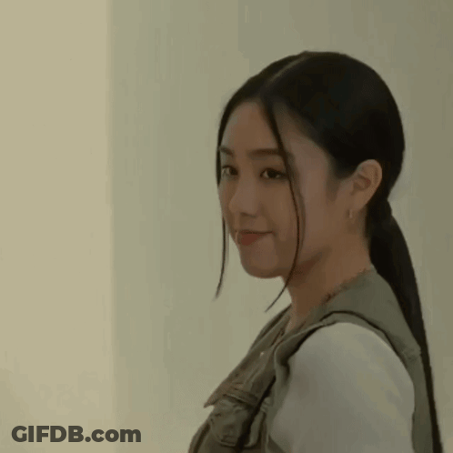 A Close Up Of A Woman With Long Hair In A Ponytail . GIF