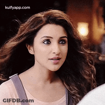 A Close Up Of A Woman With Long Hair Looking At The Camera . GIF