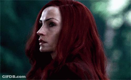 A Close Up Of A Woman With Long Red Hair GIF