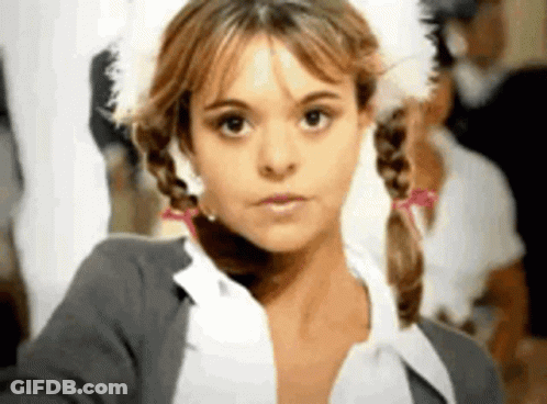 A Close Up Of A Woman With Pigtails And A Feathered Hat . GIF
