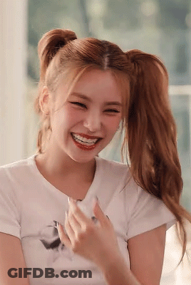 A Close Up Of A Woman With Pigtails Laughing . GIF