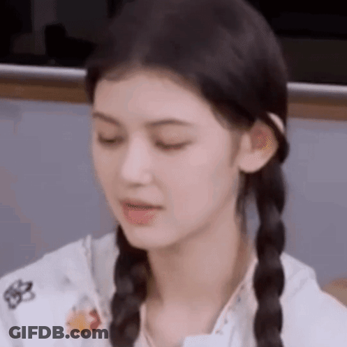 A Close Up Of A Woman With Pigtails Making A Face . GIF