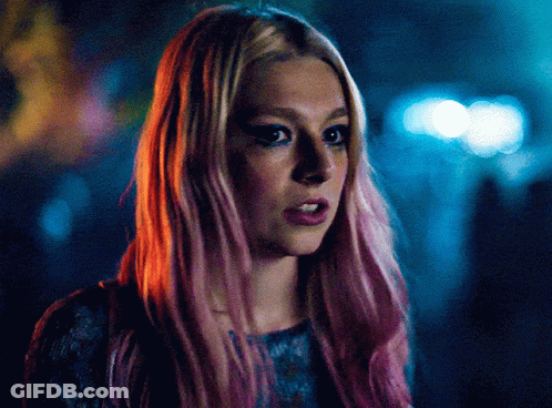 A Close Up Of A Woman With Pink Hair And Blue Eyes GIF