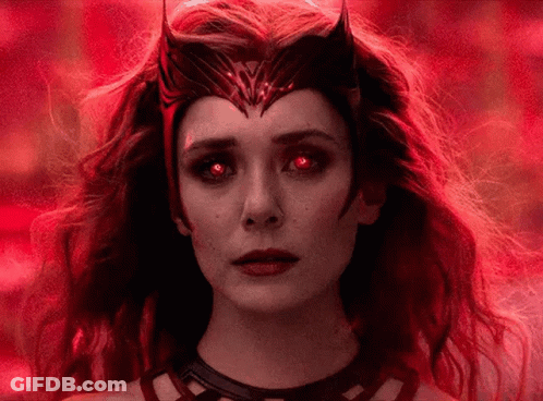 A Close Up Of A Woman With Red Eyes And A Crown On Her Head . GIF