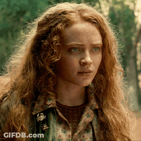 A Close Up Of A Woman With Red Hair GIF