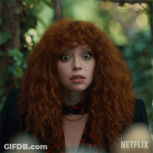 A Close Up Of A Woman With Red Hair And A Netflix Logo GIF