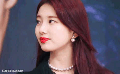 A Close Up Of A Woman With Red Hair And Red Lipstick . GIF