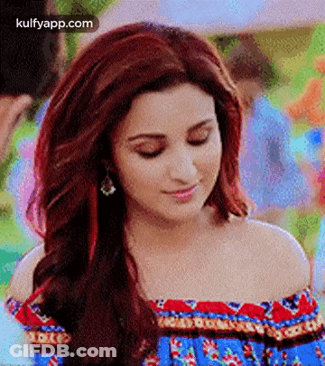 A Close Up Of A Woman With Red Hair Wearing A Blue Off The Shoulder Top . GIF