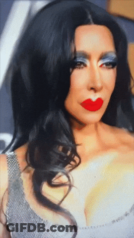 A Close Up Of A Woman With Red Lips And Blue Eyeshadow GIF