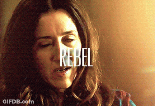 A Close Up Of A Woman With The Word Rebel Written On Her Face GIF