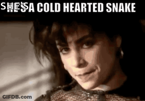 A Close Up Of A Woman With The Words She 'S A Cold Hearted Snake Above Her GIF