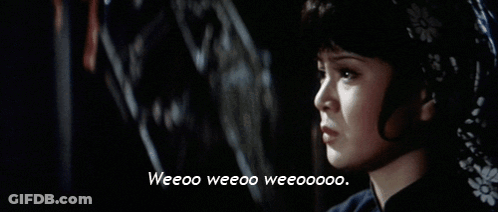 A Close Up Of A Woman With The Words Weeoo Weeoo Weeooo GIF